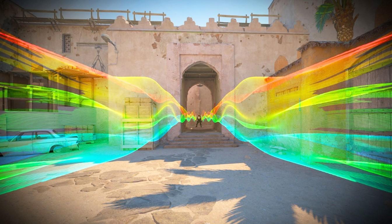 Rainbow-colored light streaks across a sandy arch and walls