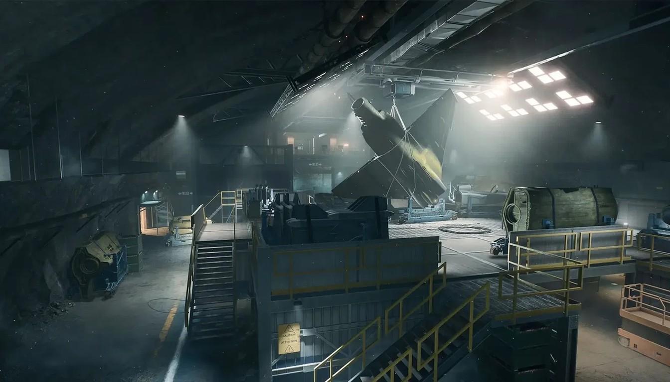 Dark underground hangar with steel walkways and floodlights