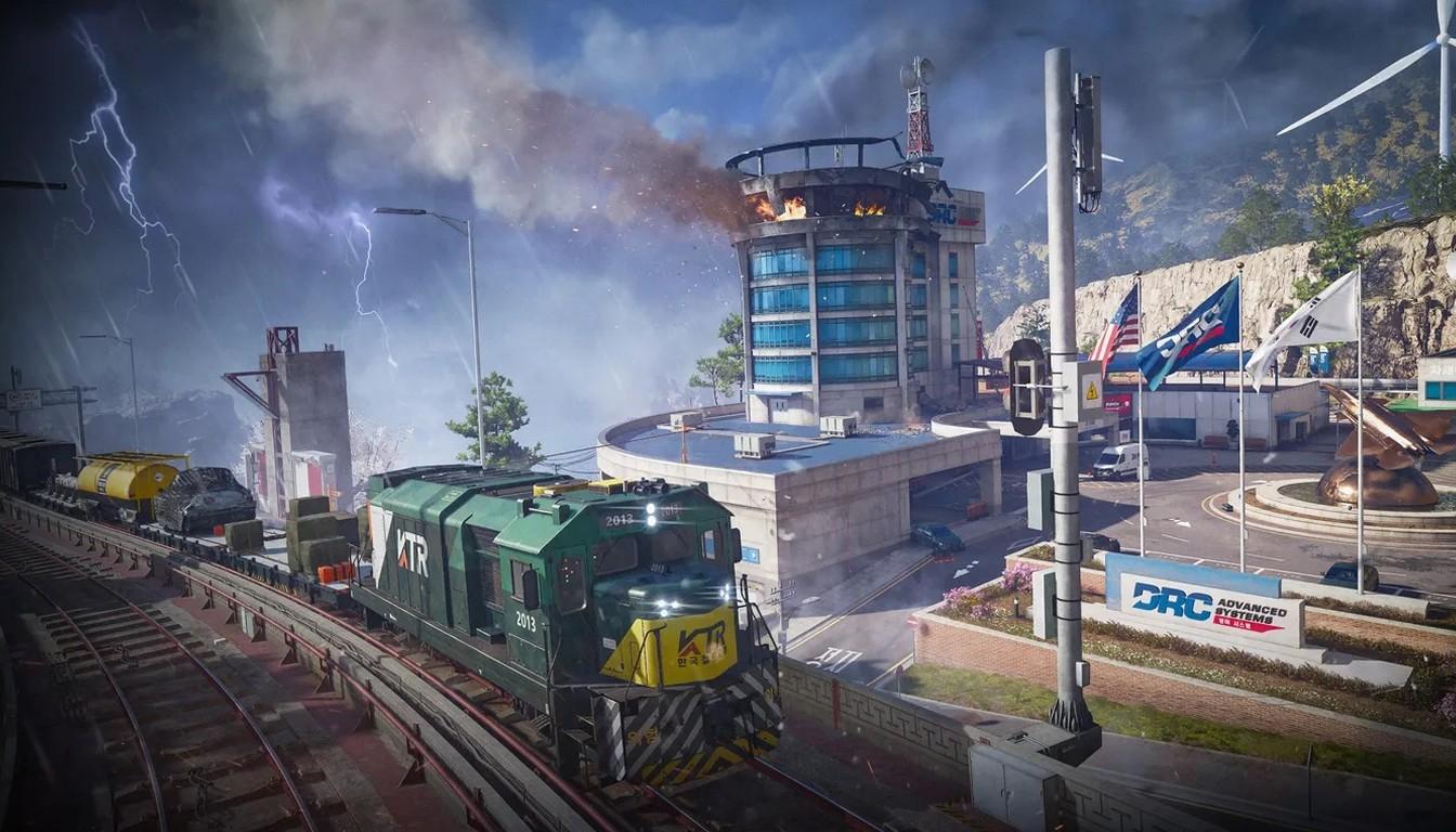 A locomotive on the Trackline railway next to a tower and buildings