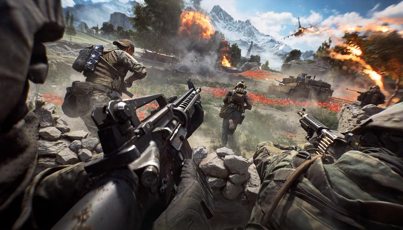 Infantry with rifles advancing through a mountain valley while tanks burn in the distance