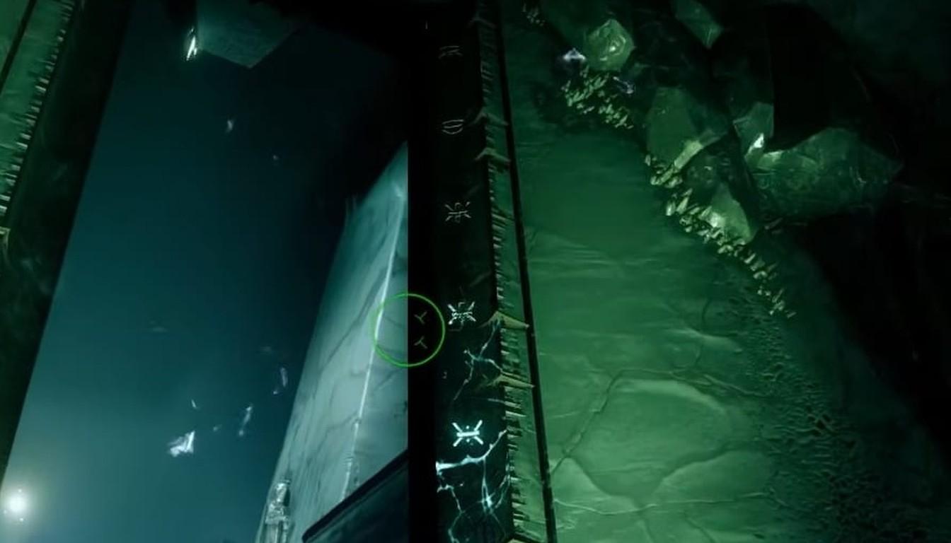Tall dark pillar beside a green corridor with rocky debris