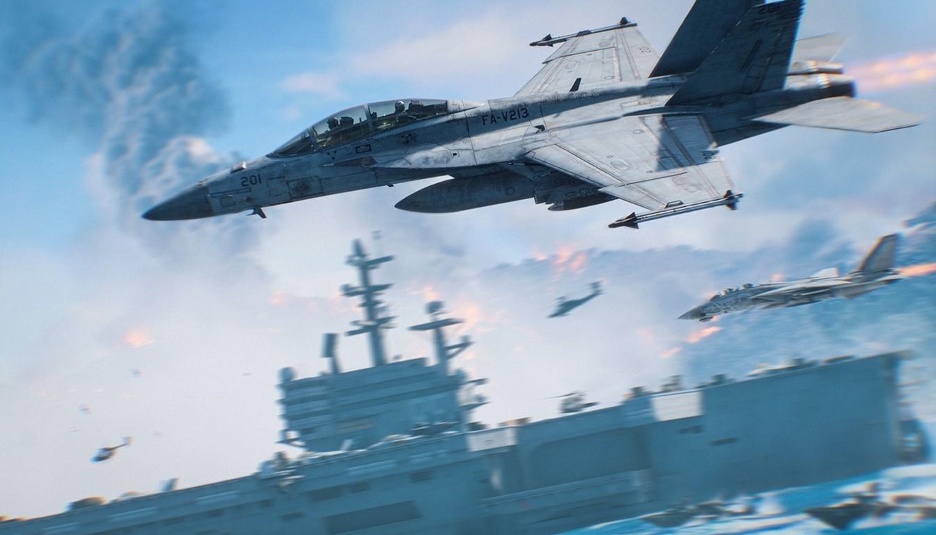 Fighter jet flying over an aircraft carrier at sea