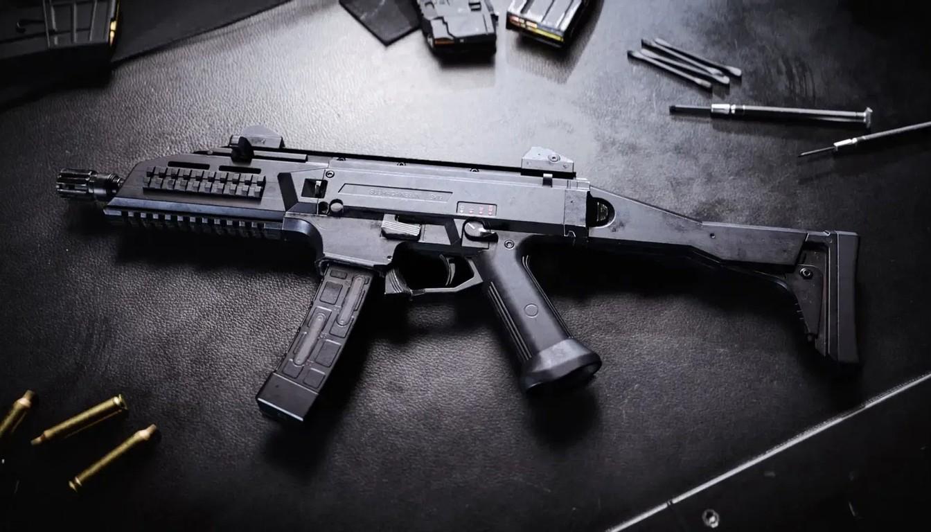 Compact submachine gun on a dark surface beside magazines and loose rounds