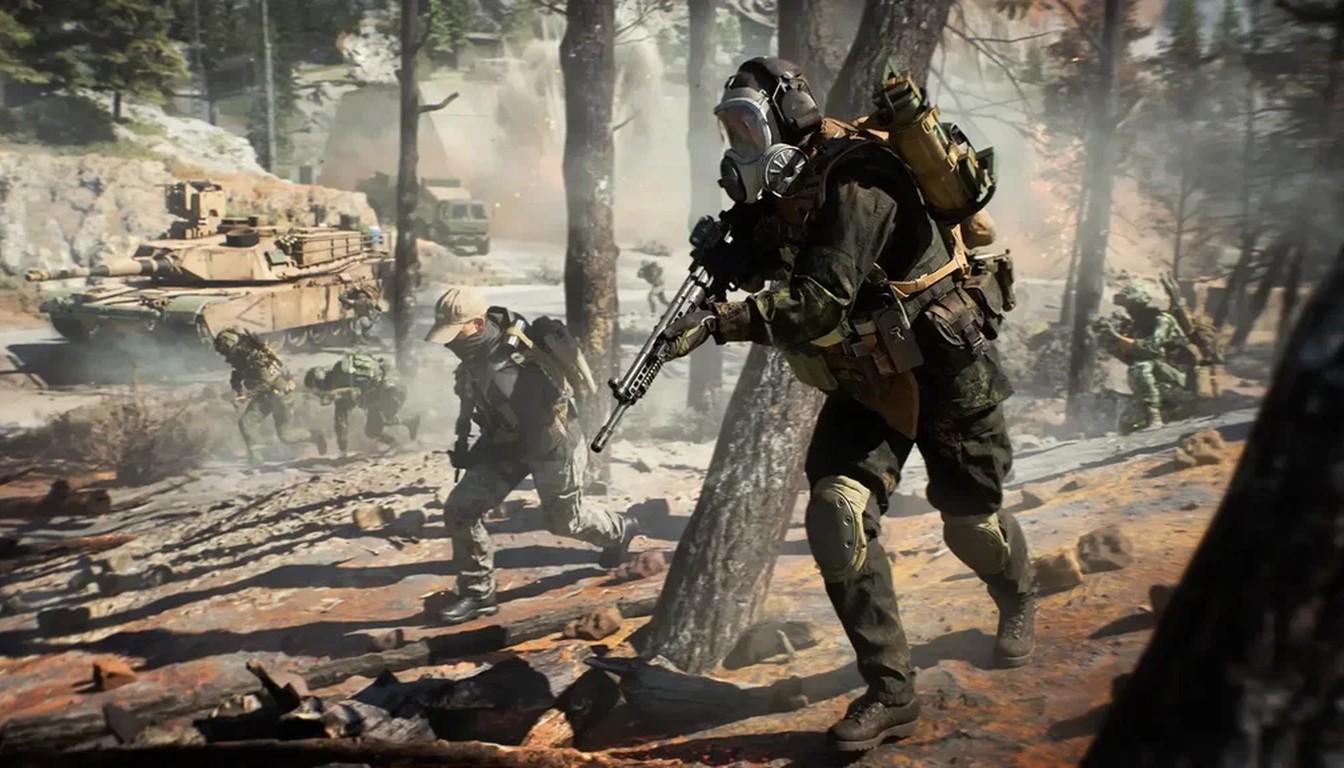 Assault soldier in a gas mask advancing through a forest with a tank behind
