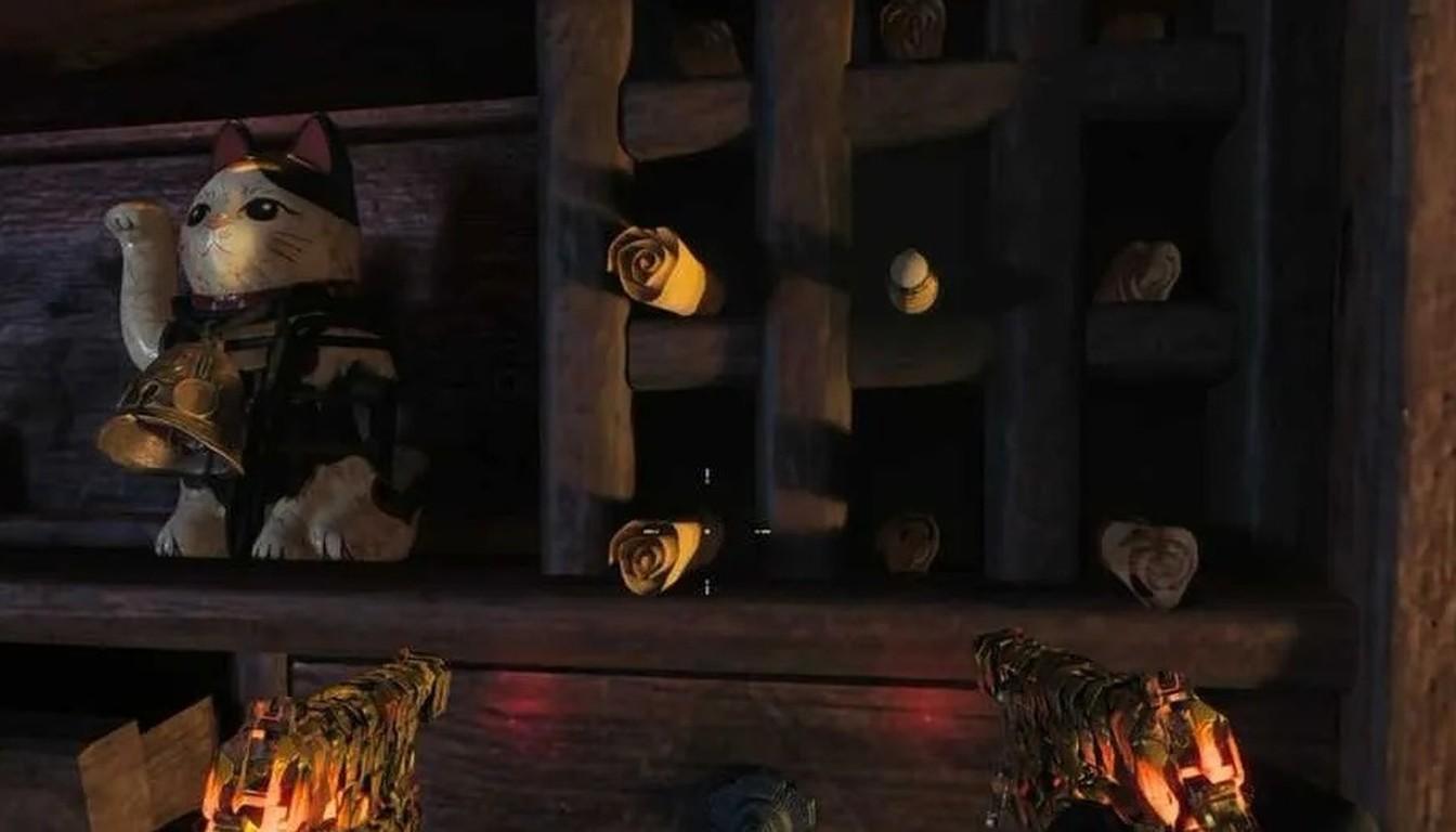 A shelf with a Maneki-neko cat figurine and wooden roses in a dark room
