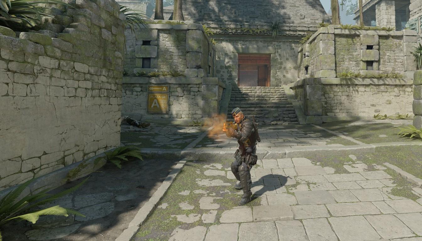 A CS2 player firing on the move in an old-town courtyard